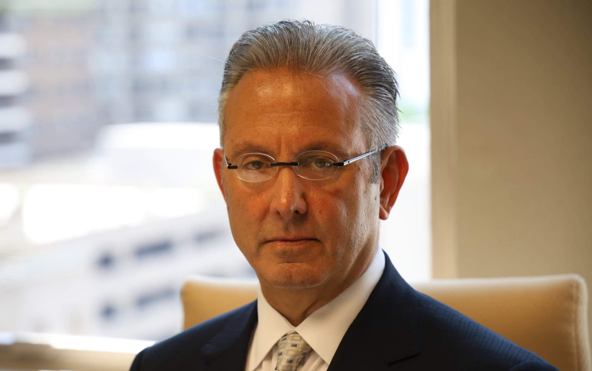 Philadelphia car accident lawyer Jeff Penneys Wearing Dark Black Suit with Gold Tie