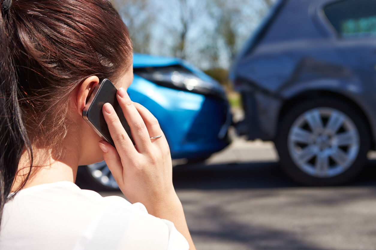 Female Driver Making Phone Call after Traffic Accident